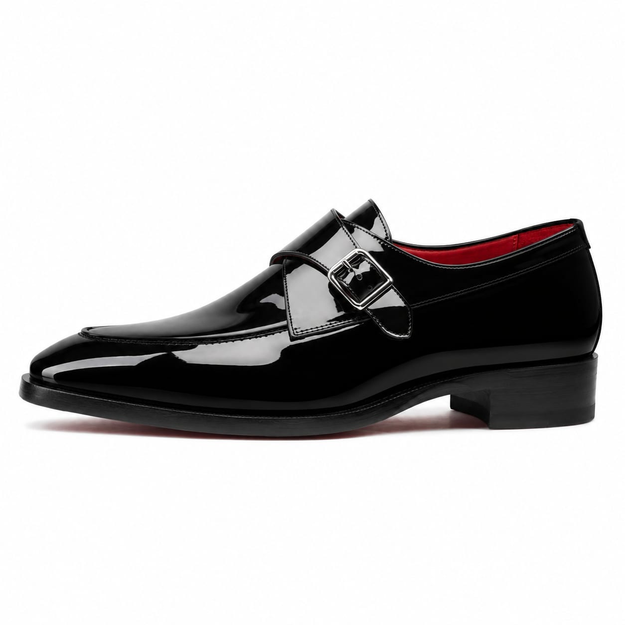 A single black patent leather monk-style dress shoe with a decorative strap and buckle detail across the vamp, shown in profile against a plain white background.
