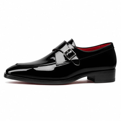 A single black patent leather monk-style dress shoe with a decorative strap and buckle detail across the vamp, shown in profile against a plain white background.