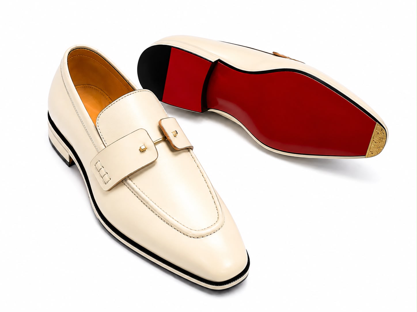 A pair of cream-colored leather loafers shown on a white background, with one shoe standing upright to display the side and the other lying down to show the distinctive red outsole.